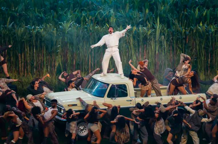 (Above: Bad Bunny commanding the stage amid dancers in a sugarcane setup, embodying Latin cultural pride during Super Bowl LX.)